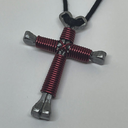 Nail cross necklace wrapped with bold burgandy wire.