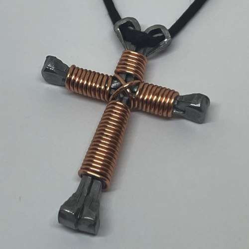 Nail cross necklace wrapped with bold copper wire.