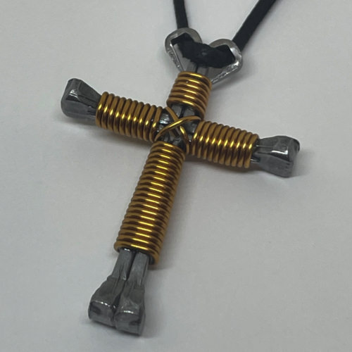 Nail cross necklace wrapped with bold gold wire.