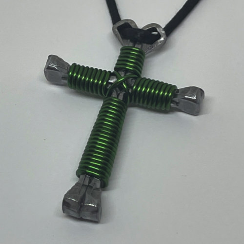 Nail cross necklace wrapped with bold green wire.