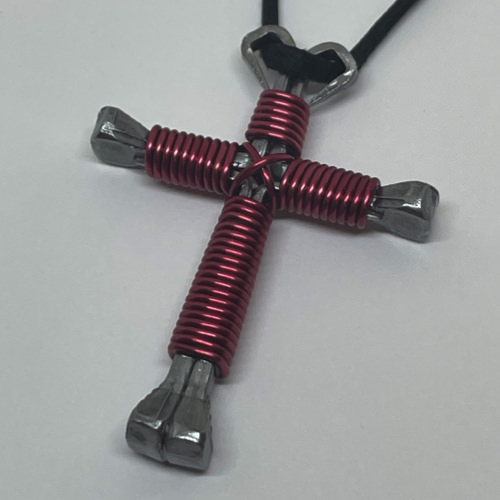Nail cross necklace wrapped with bold magenta wire.