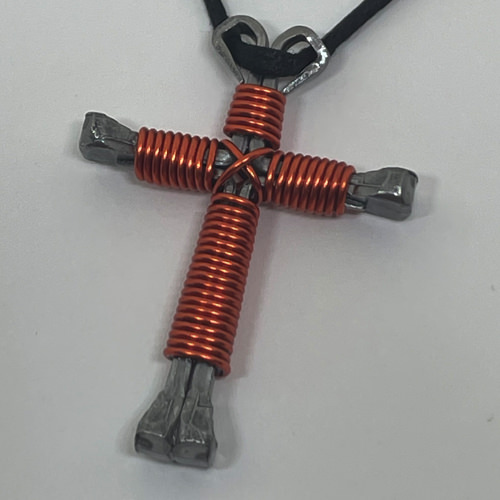 Nail cross necklace wrapped with bold orange wire.