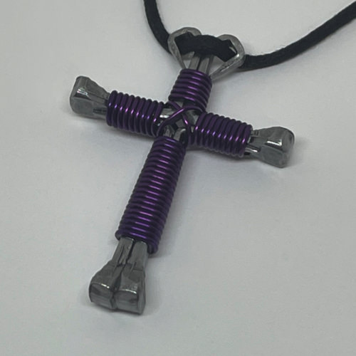Nail cross necklace wrapped with bold purple wire.