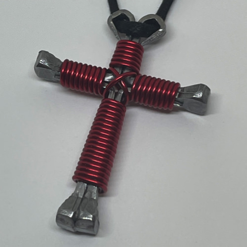 Nail cross necklace wrapped with bold red wire.