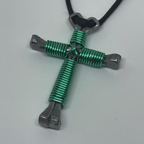 Nail cross necklace wrapped with bold seafoam wire.