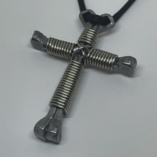 Nail cross necklace wrapped with bold silver wire.
