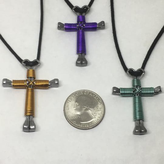 Comparing three Nail Cross Necklaces three nail cross necklaces being compared