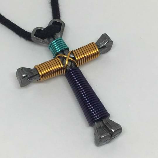 nail cross necklace made of sea green, gold and purple wire