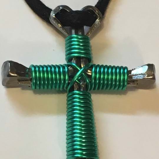 Seafoam nail cross necklace showing the vibrant color of the enamel wire